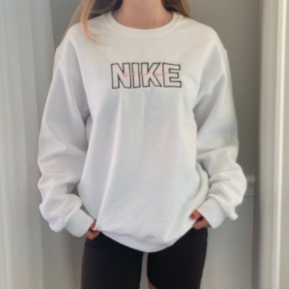 White crewneck with black "Nike" and pink swooshes